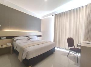 Ένα ή περισσότερα κρεβάτια σε δωμάτιο στο Sumi Hotel Surabaya +136 φωτογραφίες