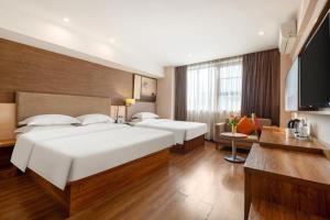 Giường trong phòng chung tại Jtour Inn Chongzuo Ningming +112 ảnh