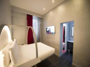 a small room with a bed and a mirror at iRooms Central Station in Rome