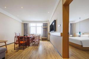 une chambre d'hôtel avec un lit et une table à manger dans l'établissement City Comfort Inn Wuhan Hongshan District Baishazhou Huangjiahu University Town, à Wuhan