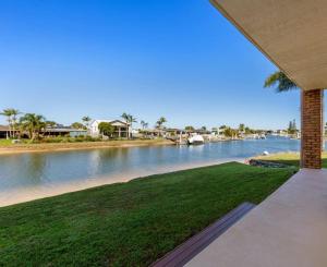 a view of a river from the porch of a house at Barooga1- Mooloolaba Canal Front Apartment in Mooloolaba