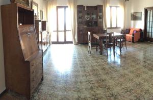 a living room with a dining room table and chairs at B&b Sulis in Alghero