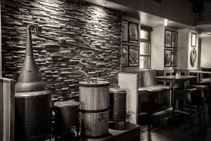 a restaurant with a stone wall and a bar with stools at Mulcahys in Clonmel