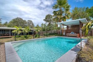 a swimming pool in the backyard of a house at Jalun Bayun The Sea House in Newell Beach