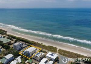 an aerial view of the beach and the ocean at Above The Dunes in Woorim