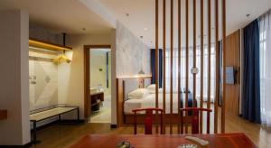 Postel nebo postele na pokoji v ubytování Borrman Hotel Shaoguan Nanxiong Rt-Mart