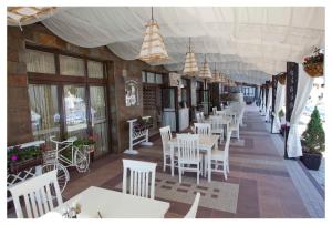 a row of tables and chairs in a restaurant at Europroperties Bendita Mare Apartments in Golden Sands