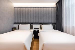 Ένα ή περισσότερα κρεβάτια σε δωμάτιο στο Atour Light Hotel Beijing Zhongguancun Renmin University