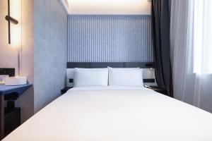 Ένα ή περισσότερα κρεβάτια σε δωμάτιο στο Atour Light Hotel Beijing Zhongguancun Renmin University