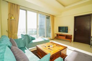 a living room with a couch and a table at UNA Services - Elysium Apartments in Islamabad