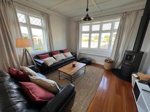 a living room with a couch and a coffee table at Sackville Retreat in Martinborough