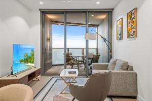 a living room with a couch and a table at Sky Living & River Views in Queens Wharf Residences in Brisbane