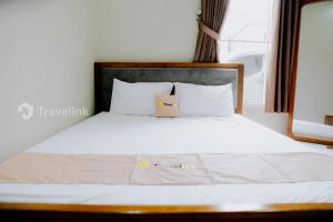 Giường trong phòng chung tại Dieng Top Syariah By Travelink