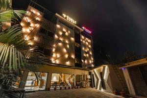 a building with lights on the side of it at night at Topaz hotel in Bilāspur