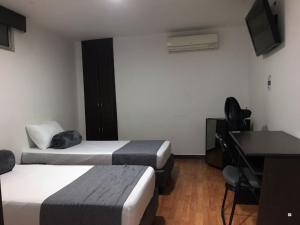 TV a/nebo společenská místnost v ubytování Hotel Castellon Plaza Pereira