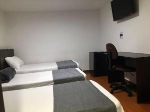 Postel nebo postele na pokoji v ubytování Hotel Castellon Plaza Pereira