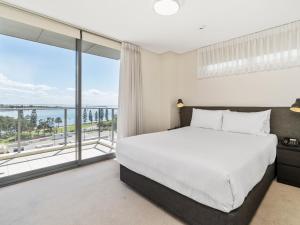 a bedroom with a bed and a large window at Terminus Apartment Hotel, an Ascend Collection Hotel in Newcastle
