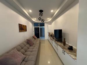 a living room with a large couch and a television at Silver Palm Tree Villa - 2 Bedrooms Villa in Ao Nang Beach