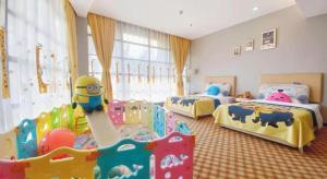a childrens bedroom with two beds and a play area at Nanning Yongjiang Hotel in Nanning