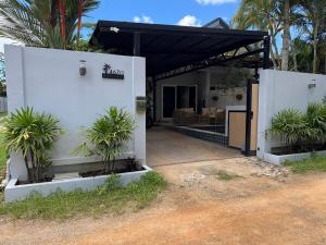 a white house with palm trees in front of it at Silver Palm Tree Villa - 2 Bedrooms Villa in Ao Nang Beach