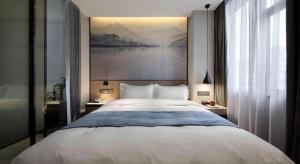 Postel nebo postele na pokoji v ubytování Shenzhen Hanyong Hotel Fuyong Branch