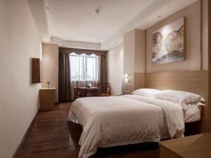 a hotel room with a large bed and a window at T Social Hotel Guangzhou Railway Station Branch in Guangzhou +286 photos