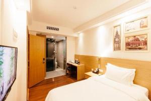 a hotel room with a bed and a bathroom at T Social Hotel Guangzhou Railway Station Branch in Guangzhou