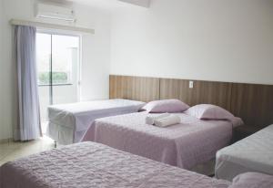 Postel nebo postele na pokoji v ubytování Hotel Dorta's