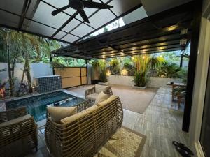 a patio with a pool and chairs and a ceiling at Silver Palm Tree Villa - 2 Bedrooms Villa in Ao Nang Beach