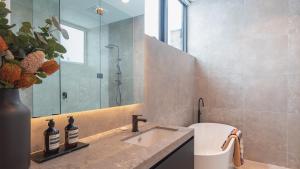 a bathroom with a sink and a shower at Peak Chalet in Mount Hotham