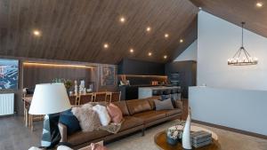 a living room with a couch and a table at Peak Chalet in Mount Hotham +21 photos
