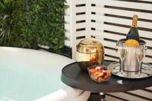 a table with a bottle of wine and a bowl of fruit at Harington's Boutique Hotel in Bath