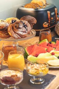 a table topped with different types of bread and fruit at Harington's Boutique Hotel in Bath