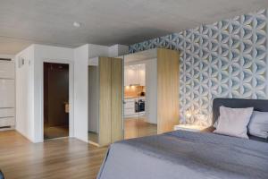 a bedroom with a large bed and a kitchen at Ferienwohnung Frieda in Frickingen