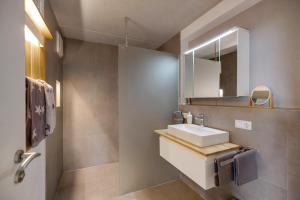 a bathroom with a sink and a mirror at Ferienwohnung Frieda in Frickingen +18 photos