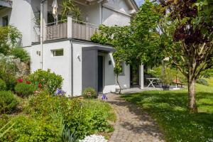 a white house with a walkway in front of it at Ferienwohnung Frieda in Frickingen