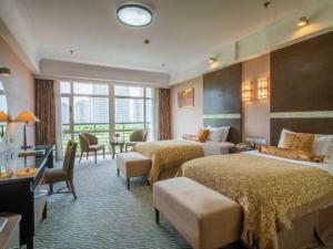 Postel nebo postele na pokoji v ubytování Dongying Blue Horizon Intenational Hotel