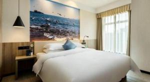 Un pat sau paturi într-o cameră la hailihotel