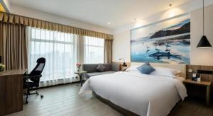 Un pat sau paturi într-o cameră la hailihotel