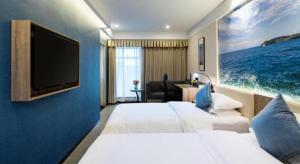 Un pat sau paturi într-o cameră la hailihotel