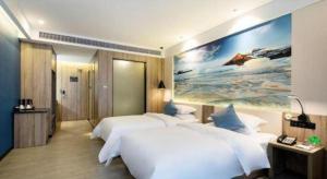 Un pat sau paturi într-o cameră la hailihotel