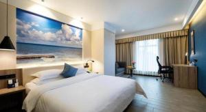 Un pat sau paturi într-o cameră la hailihotel
