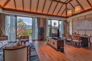 a living room with a couch and a table at Narada Resort Hotel Sanya Pleasant Bay in Sanya