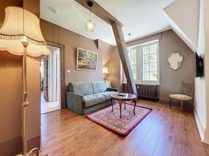 a living room with a couch and a table at Sahler Duplex 20th-Century Château in Exincourt