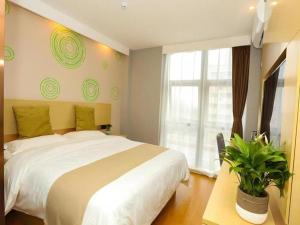 a bedroom with a large white bed and a window at GreenTree Inn Suzhou Changshu Southeast Development Zone Southeast Avenue in Gujiashuigou +40 photos