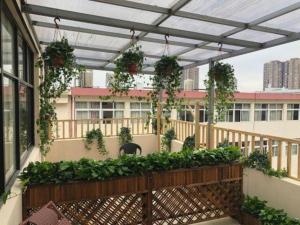a balcony with potted plants on a building at GEM Hotel Ningbo Jiangbei District Hongtang Haide Square in Kao-ch'iao