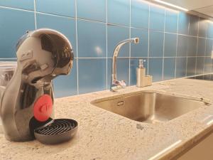 a mixer sitting on a kitchen counter next to a sink at Apartamentos Bertrand Plaza in Lorca