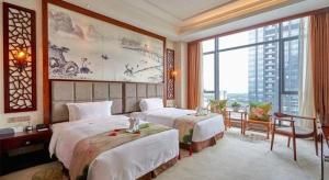 a hotel room with two beds and a large window at Eurasia Convention International Hotel in Wuhan +241 photos