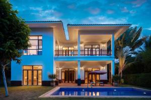 a house with a pool in front of it at Nanshan Leisure Villas in Shangsimacun