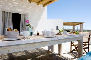 a wooden table with food on it on a patio at Milis Houses in Adamantas